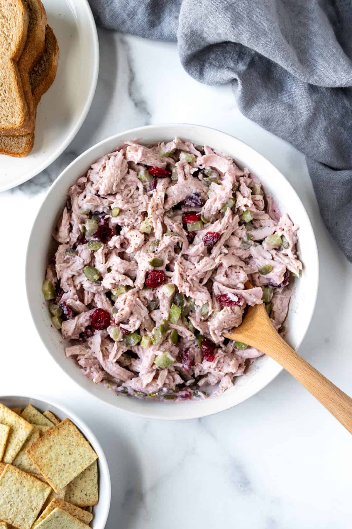Leftover Turkey Salad in a white bowl with a spoon.