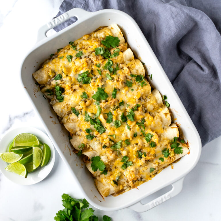 Green Chicken Enchiladas in a white baking dish.