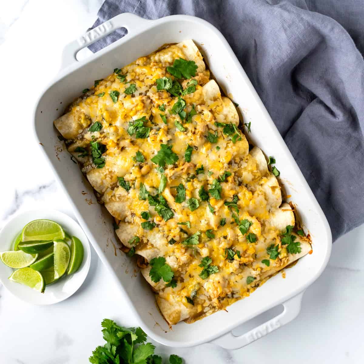 Green Chicken Enchiladas in a white baking dish.