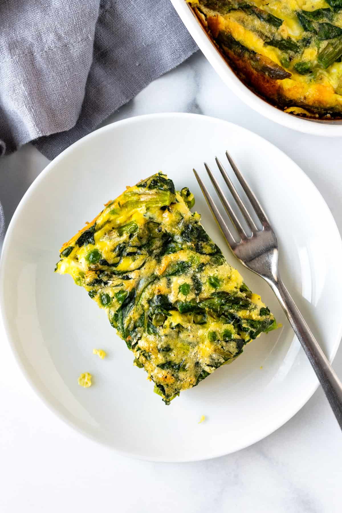 Spring Veggie Egg Casserole Piece on a white plate.