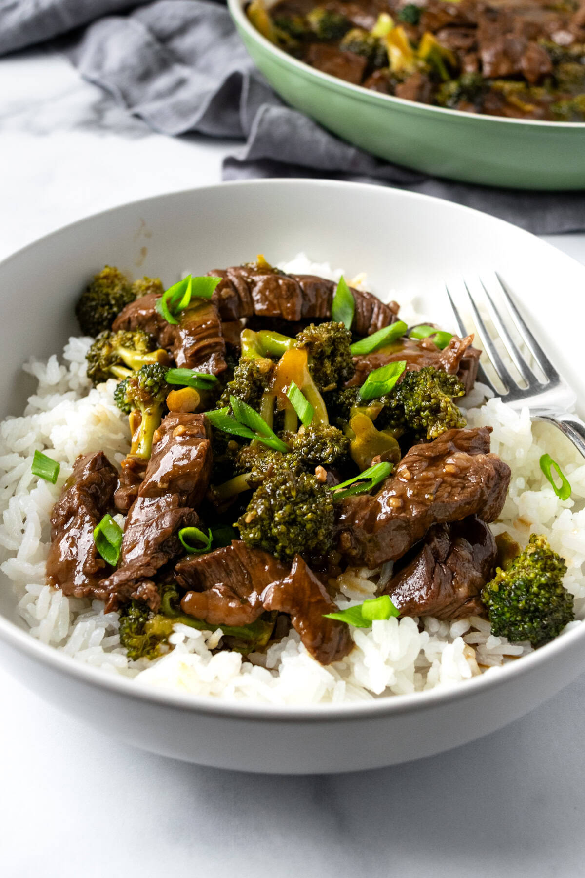 Beef and Broccoli Bowl topped with green onions.