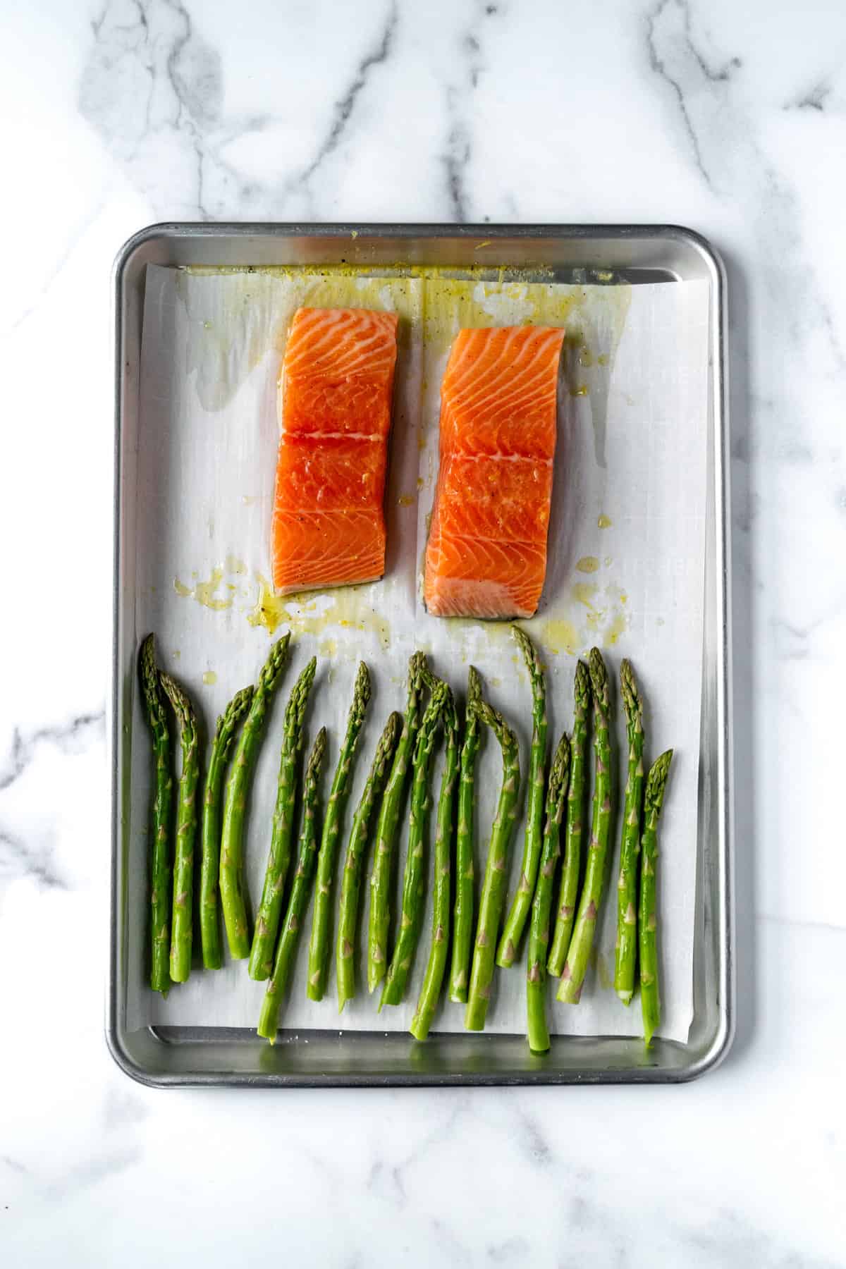 Sheet Pan Salmon and Asparagus on a baking sheet ready to bake.