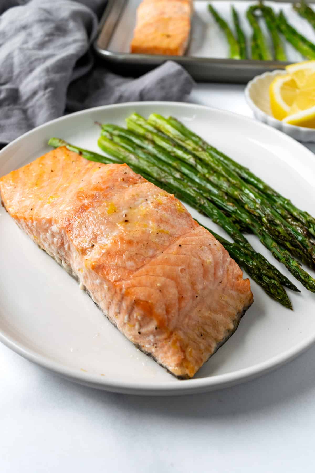 Baked Salmon and Asparagus on a white plate.