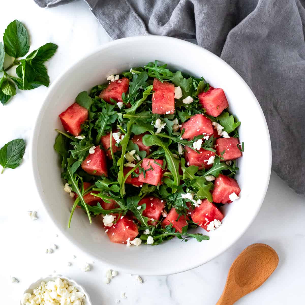 Watermelon Arugula Salad in a white bowl.
