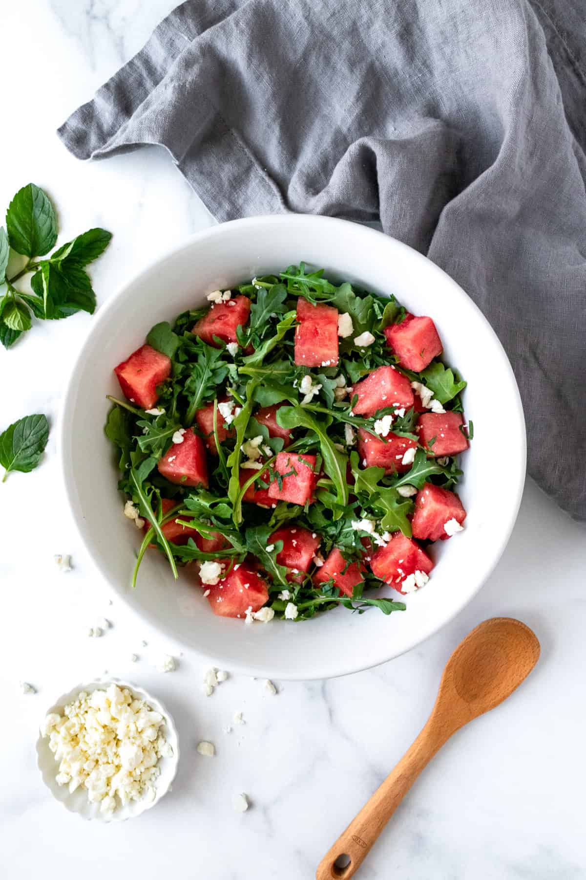 Watermelon Arugula Salad in a white bowl.