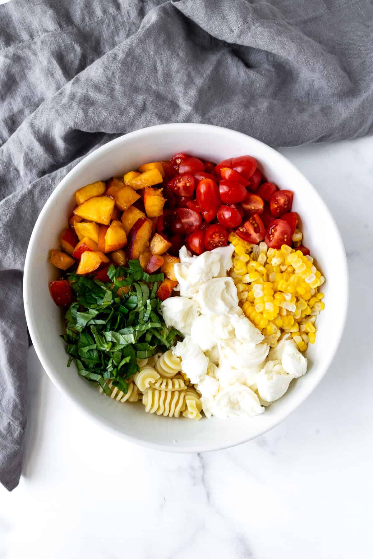 Peach and Corn Pasta Salad Ingredients in a Bowl.